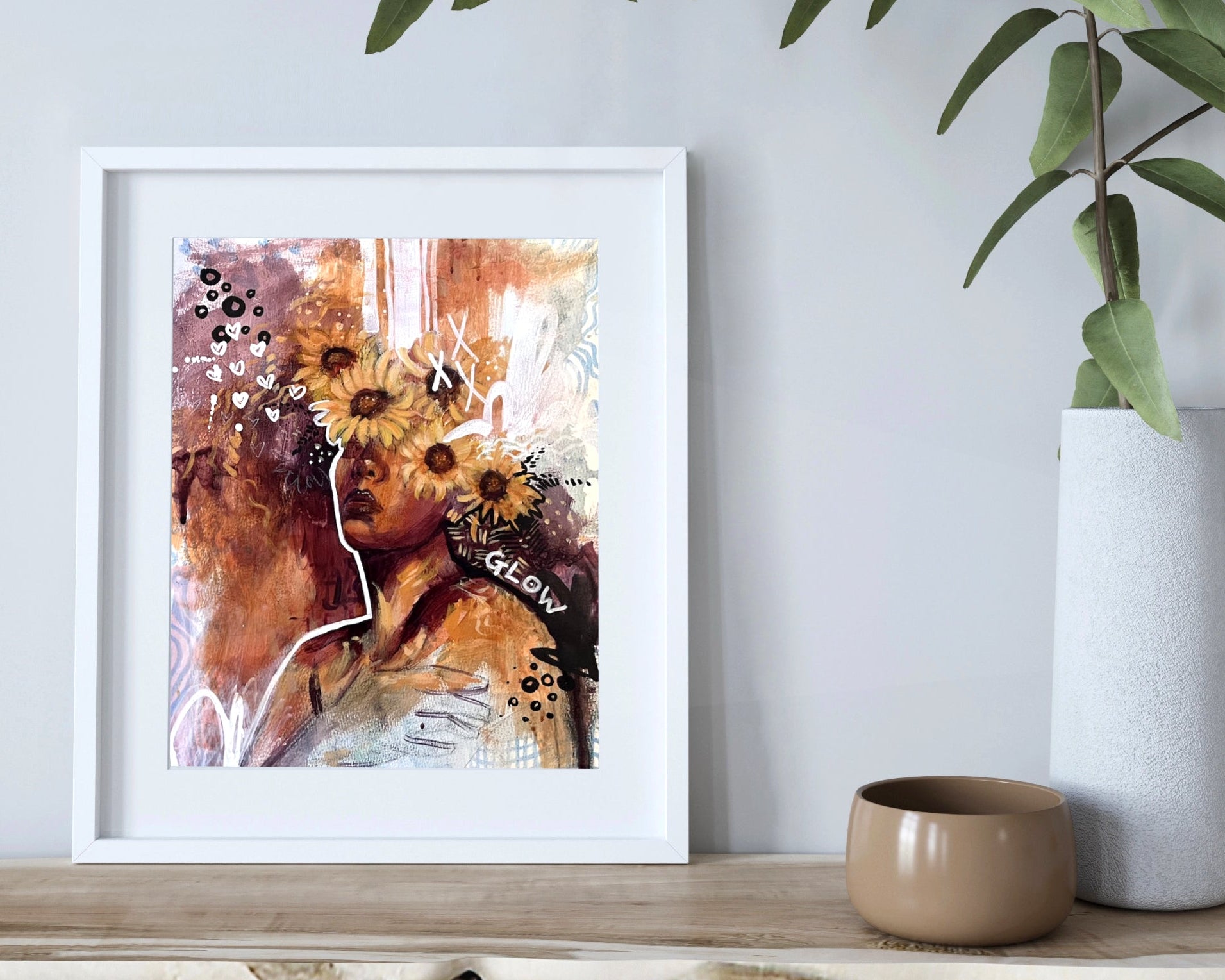 Framed abstract art print on a shelf with decorative items